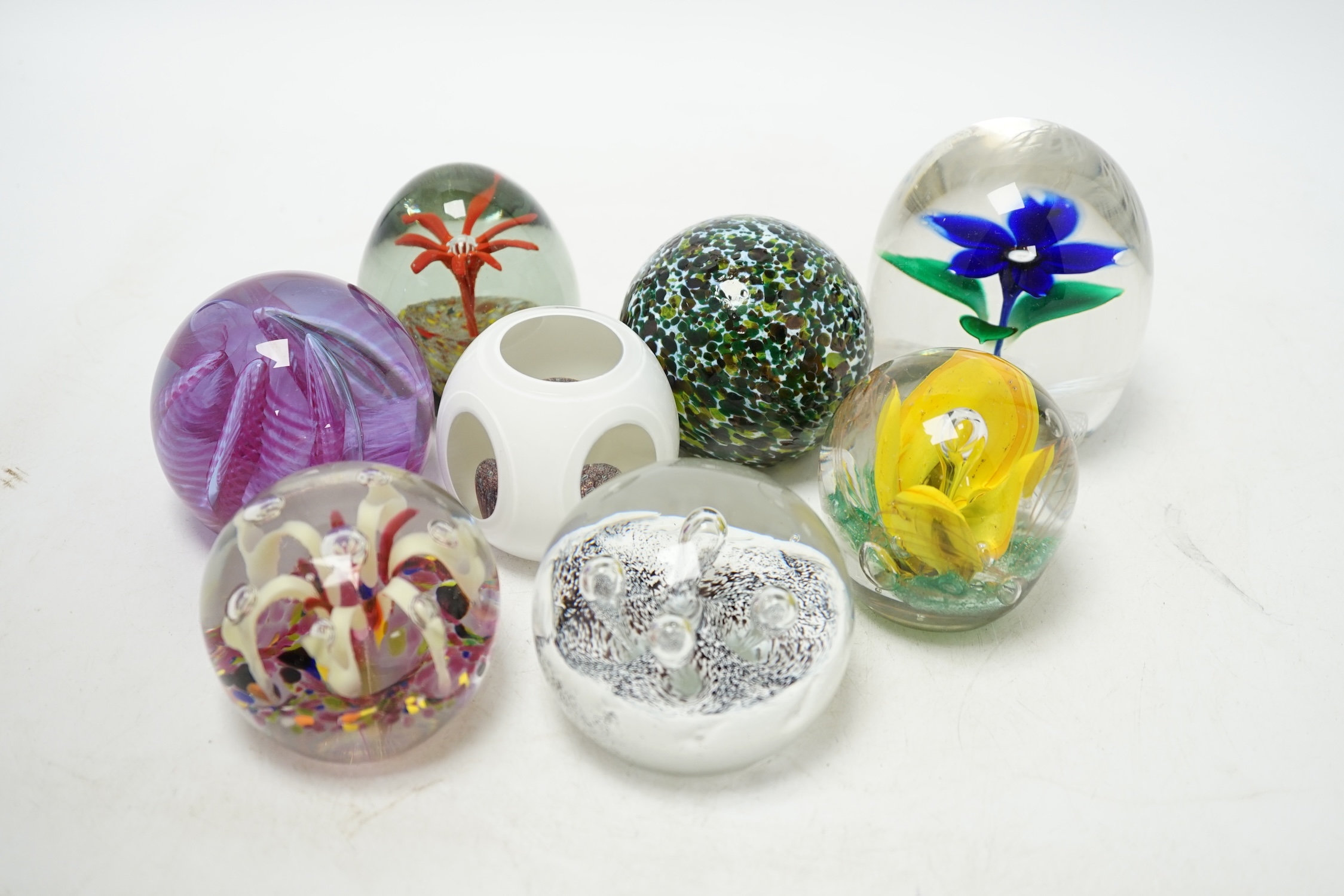 A group of eight various glass paperweights, tallest 10cm. Condition - fair to good